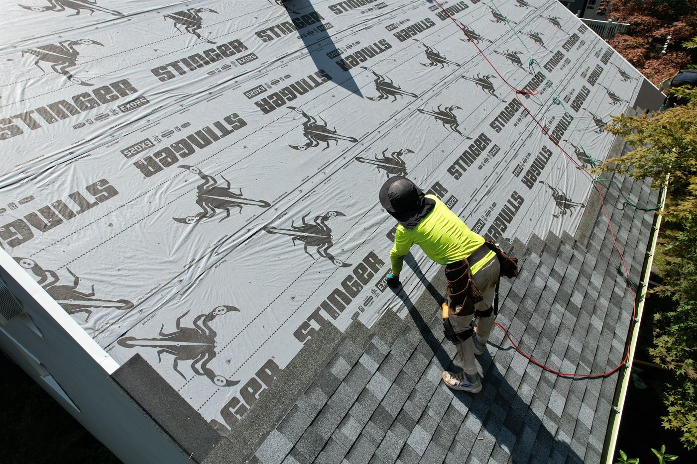 Pro Gen roofer installing architectural shingles over synthetic underlayment